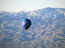 Excellent views abound of the many mountain ranges surrounding Phoenix & Scottsdale. The Hieroglyphic Mountains northwest of Lake Pleasant, shown here, provide a stunning backdrop for another balloon flying near us.
