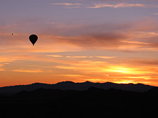 A beautiful sunset scene just before a balloon comes in for landing